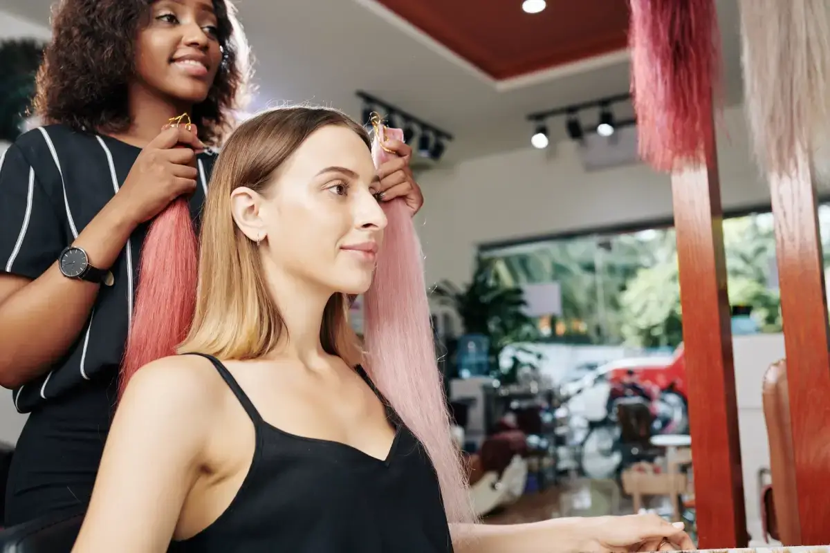 A woman getting a hair makeover in a salon.