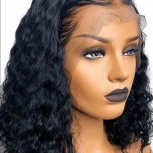 A mannequin head with curly black hair and bold makeup.