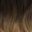 Close-up of wavy, brown hair with subtle highlights.